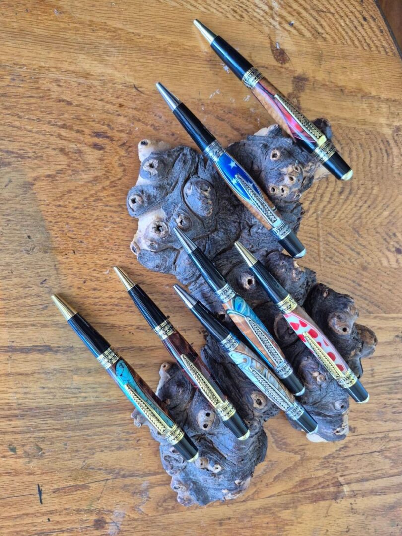 Colorful pens on textured wooden surface