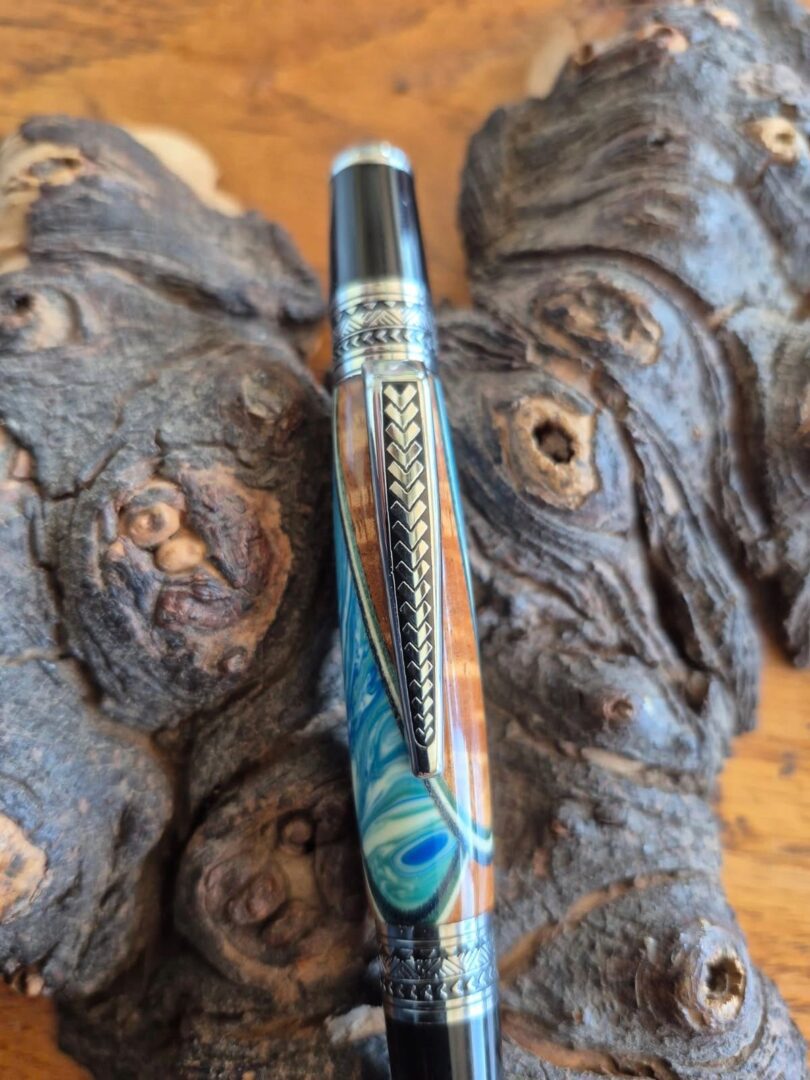 Decorative pen resting on bark