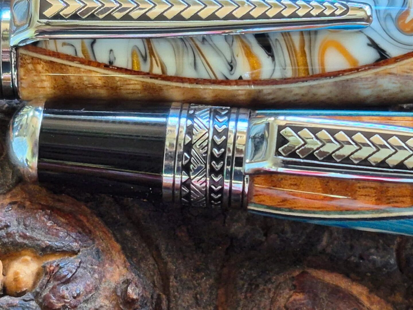 Close-up of ornate pens on wood