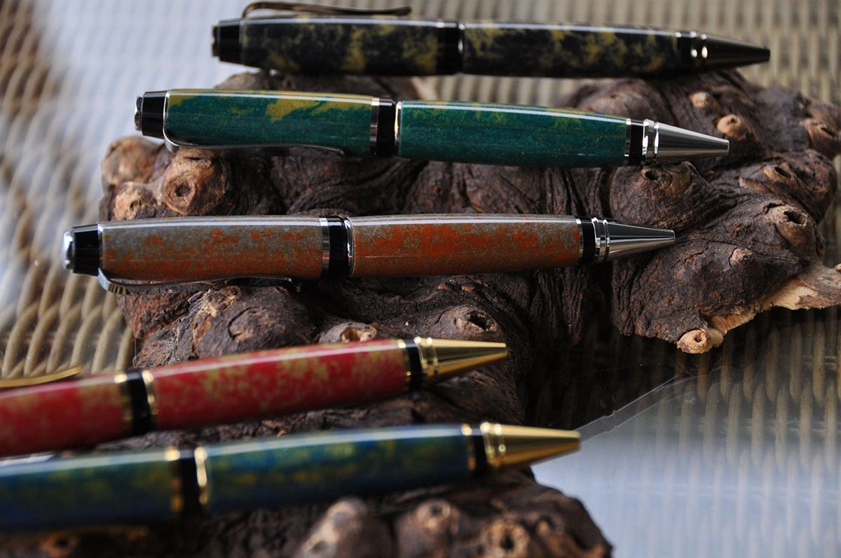 Assorted pens displayed on rustic wood