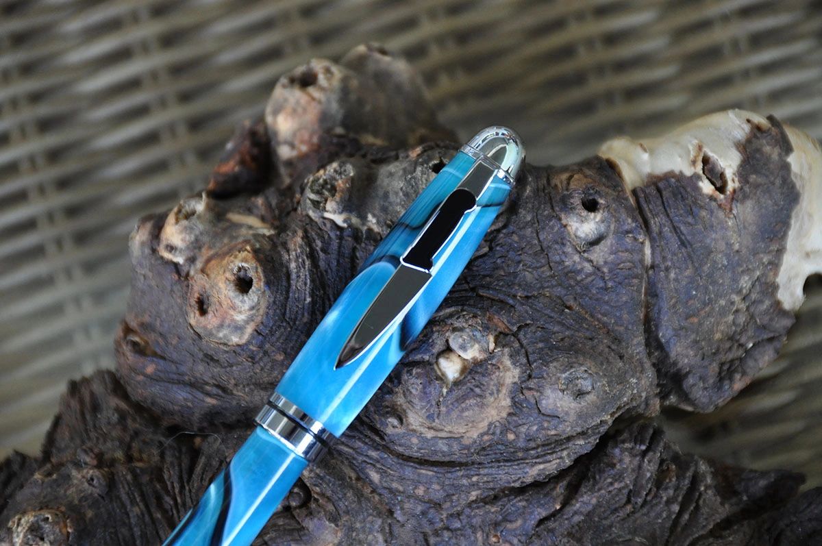 Elegant pen resting on rustic wood