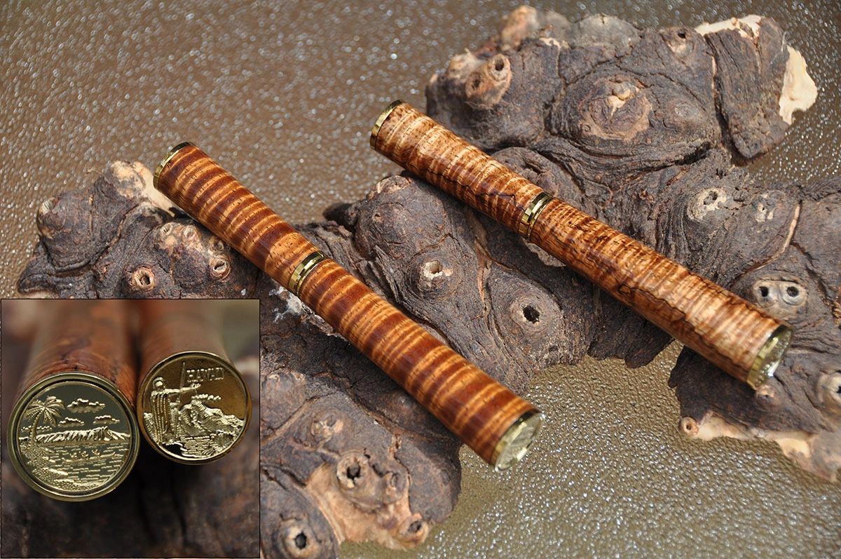 Two engraved ends of pens