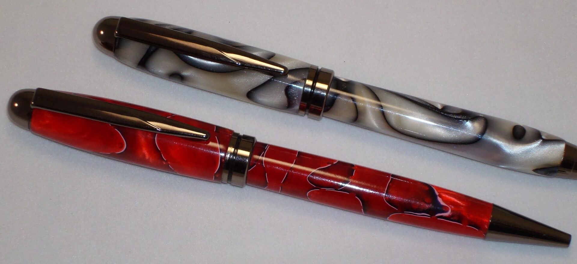 Two colorful pens with swirling designs