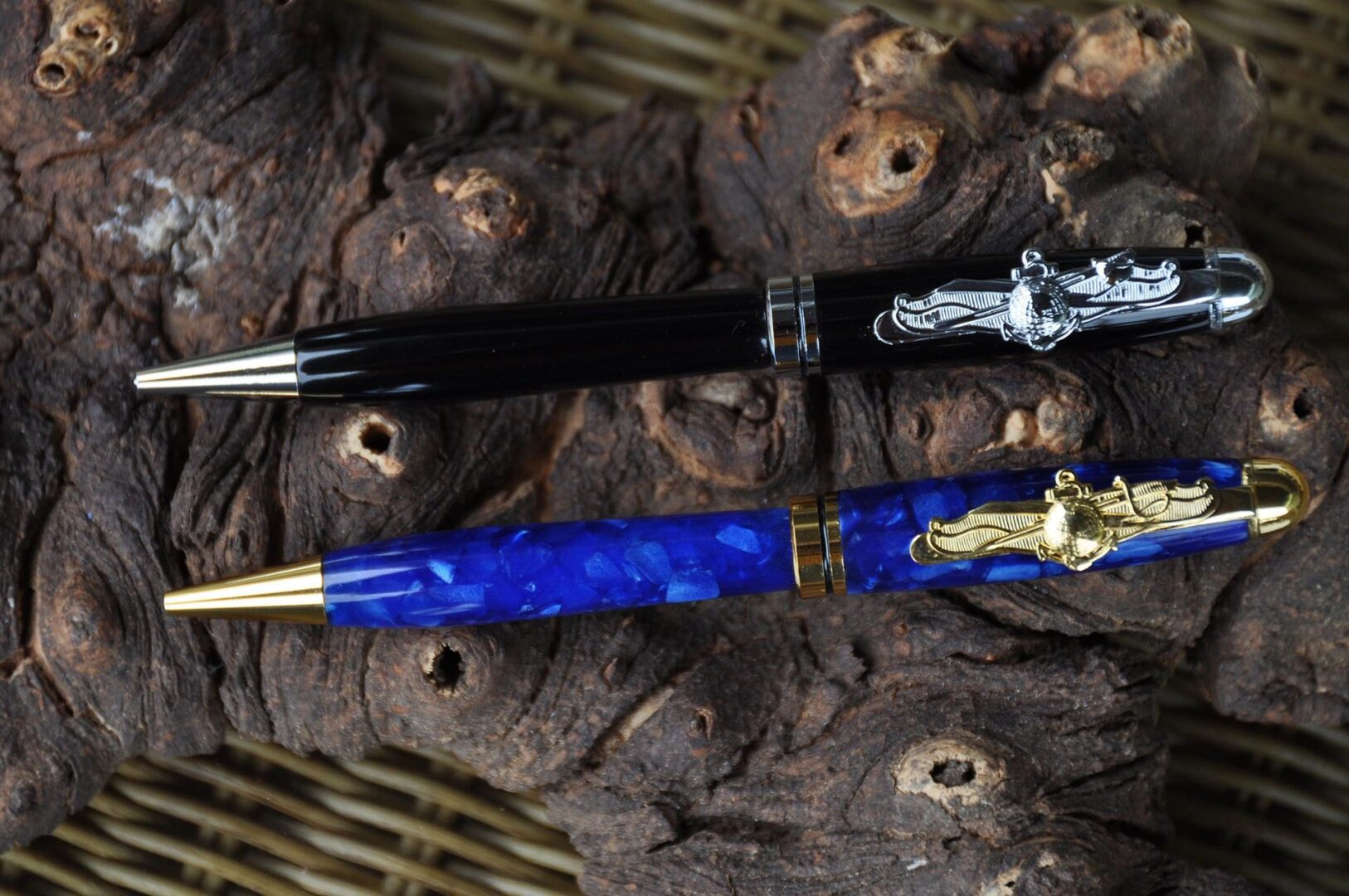 Two elegant pens on wooden background