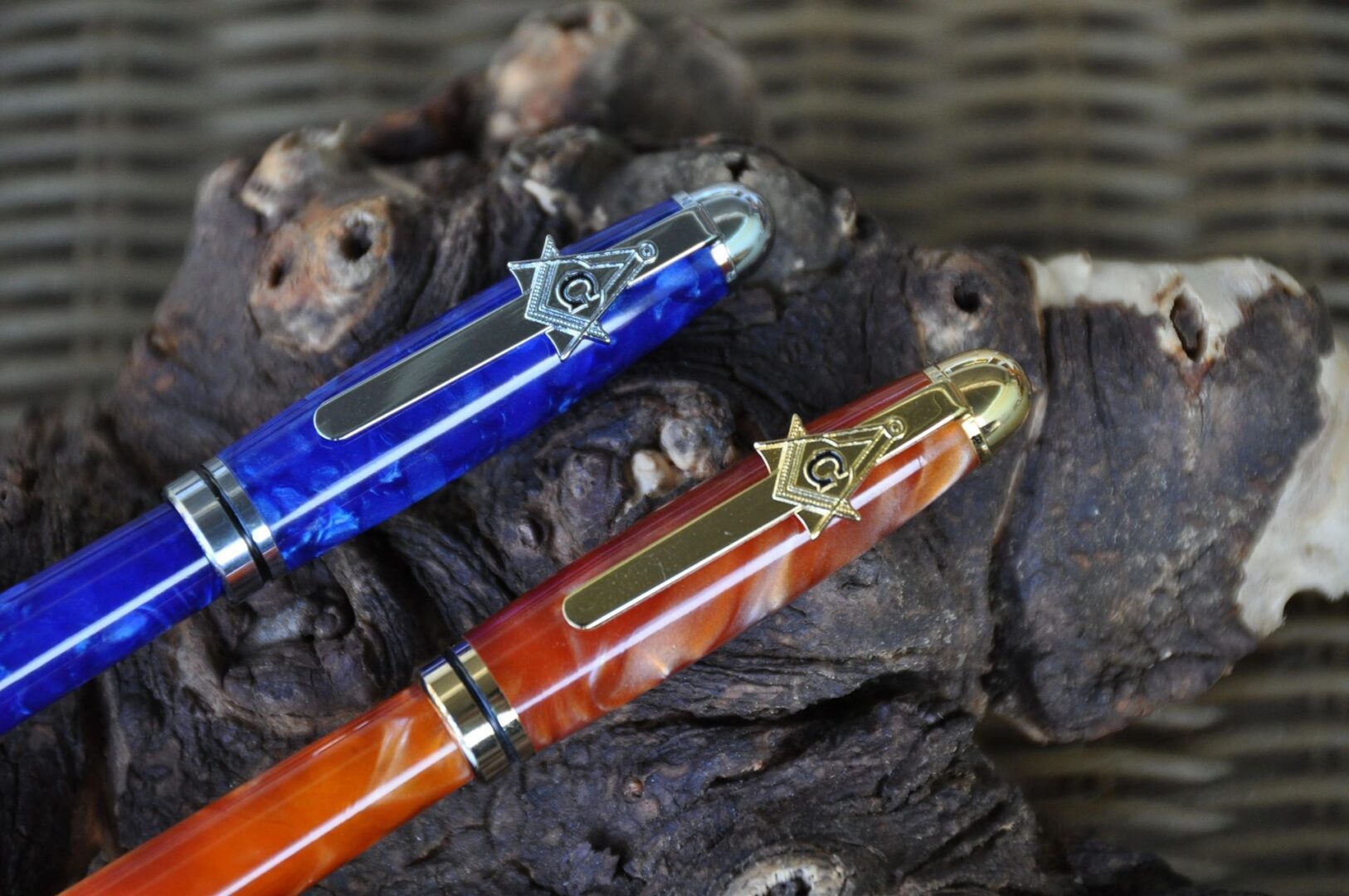 Two colorful pens on textured surface