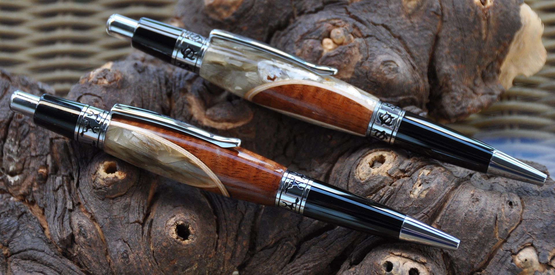 Handcrafted pens on textured wooden surface