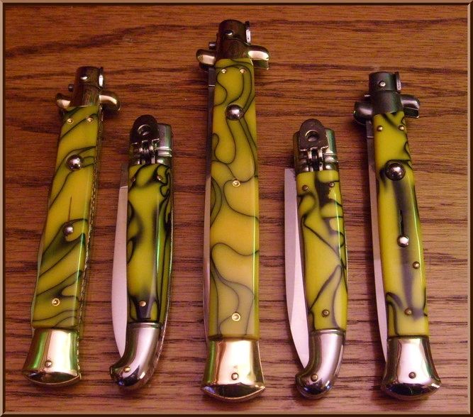 Collection of switchblades with green handles