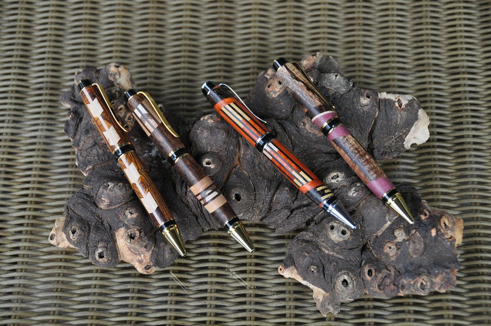 Handcrafted pens on textured wood