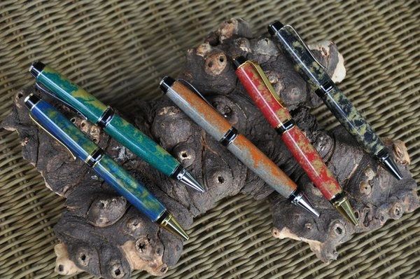 Artistic pens displayed on bark background