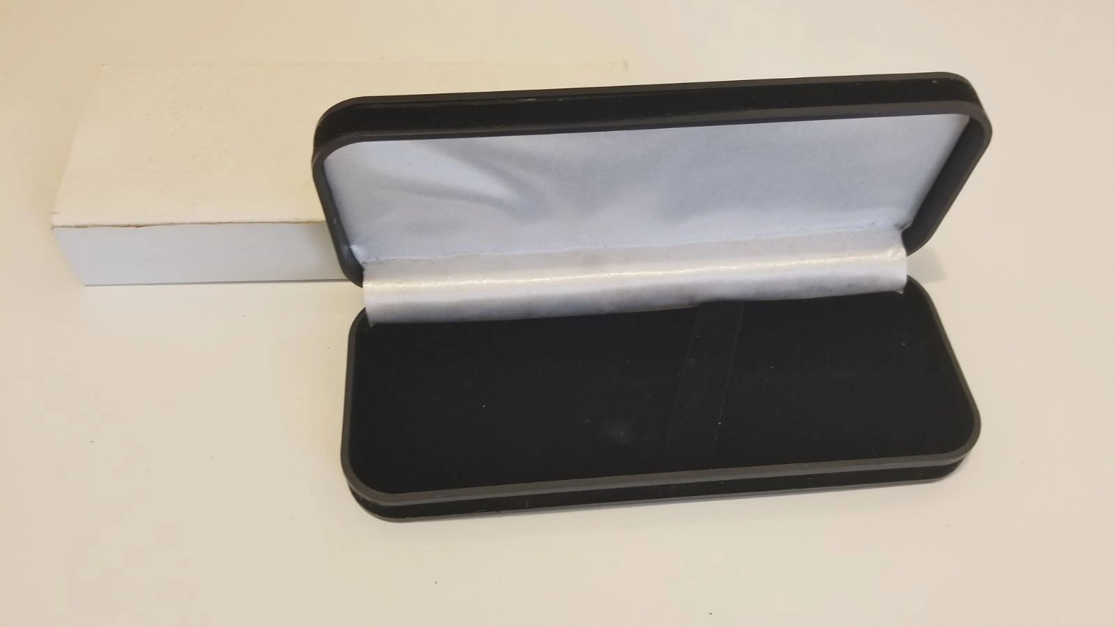 Open glasses case with white interior