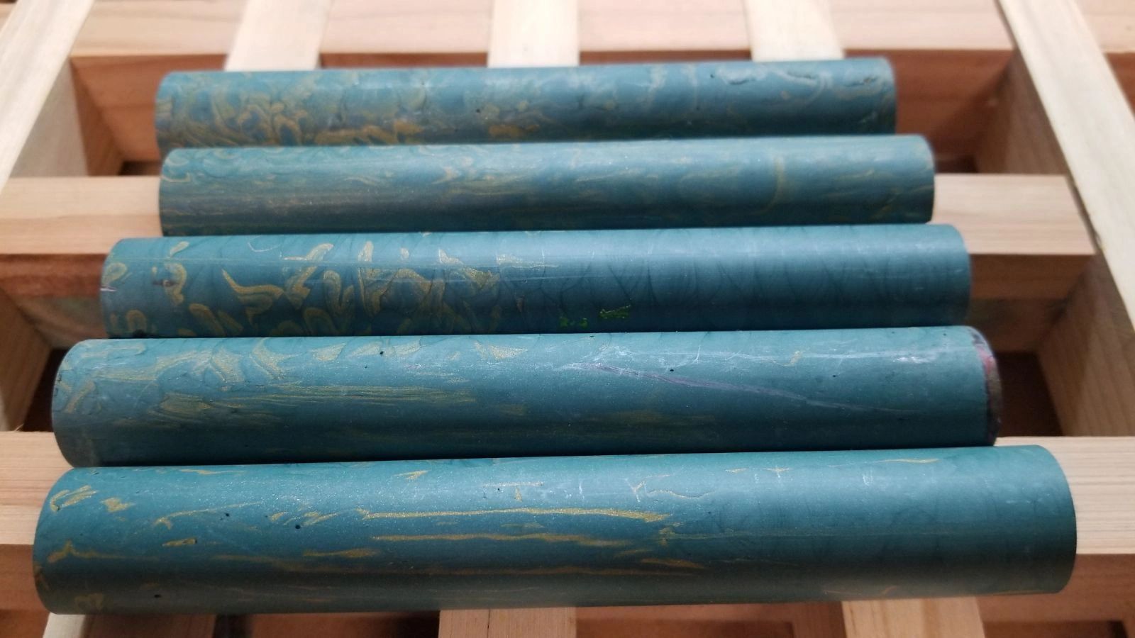 Blue cylindrical rods on wooden rack