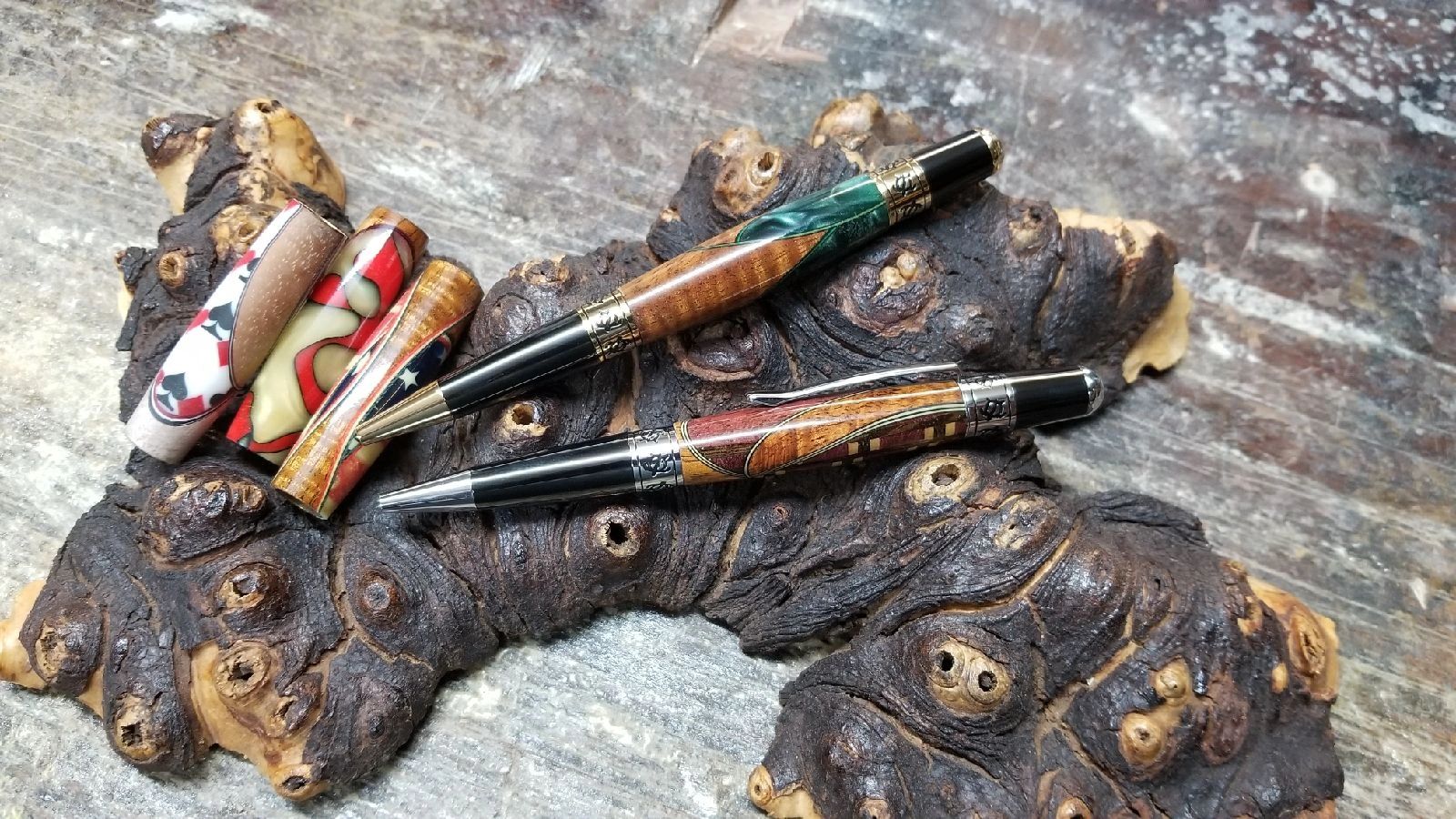 Wooden pens and rings on burl wood