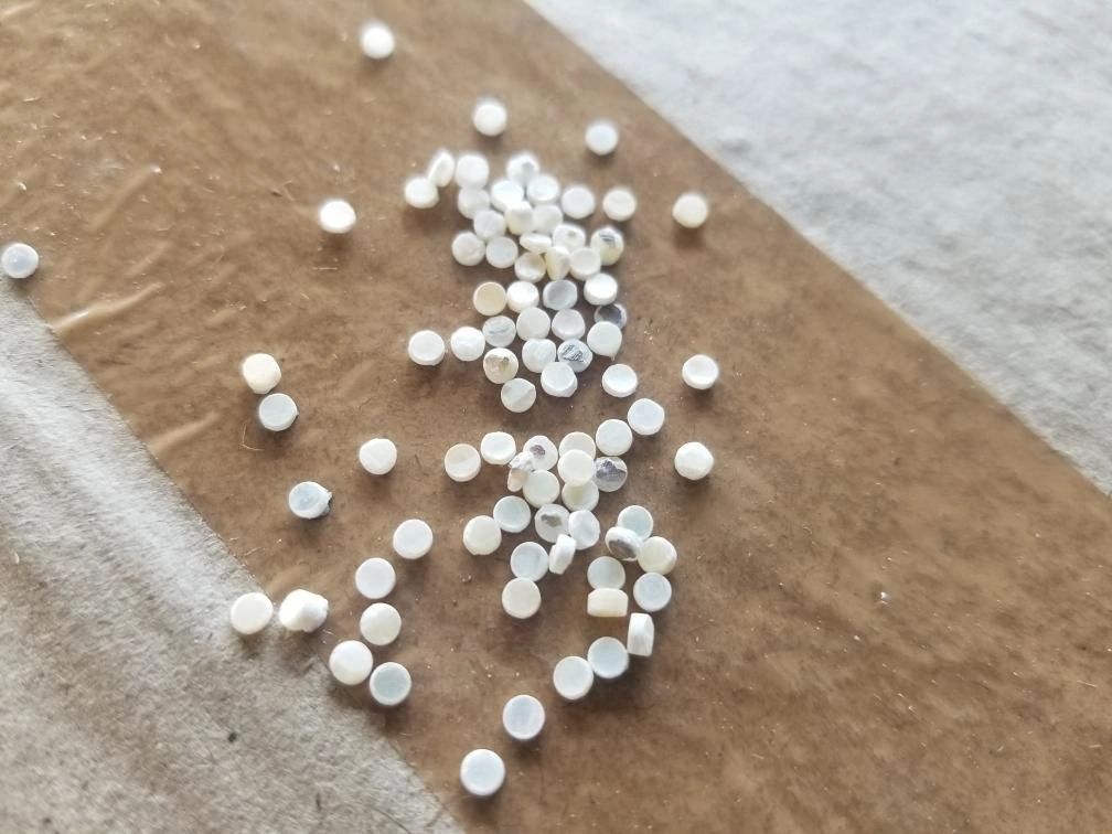 Plastic pellets on cardboard surface
