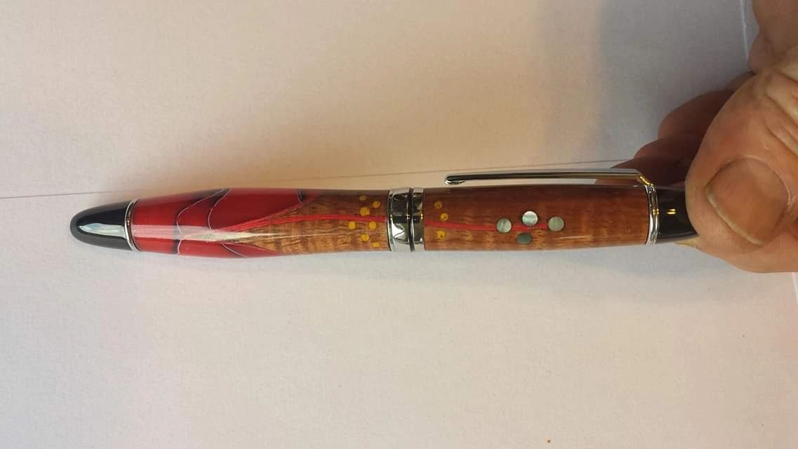 Hand holding artistic wood pen