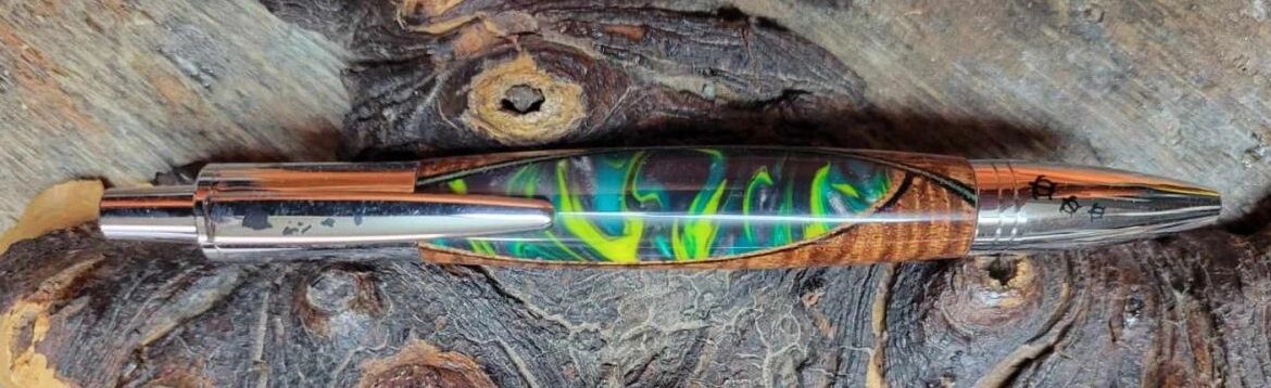 Colorful handcrafted pen on wooden surface
